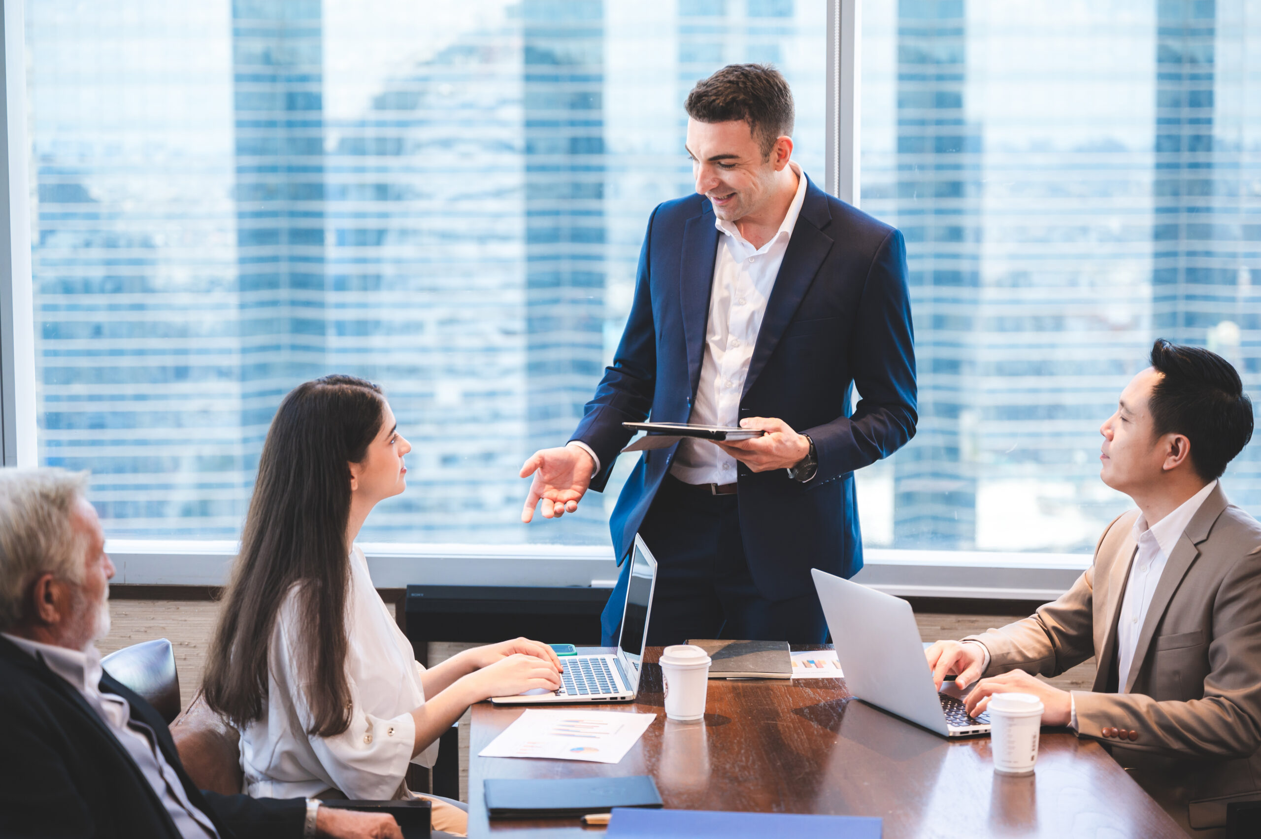Team meeting led by a manager offering guidance and leadership.