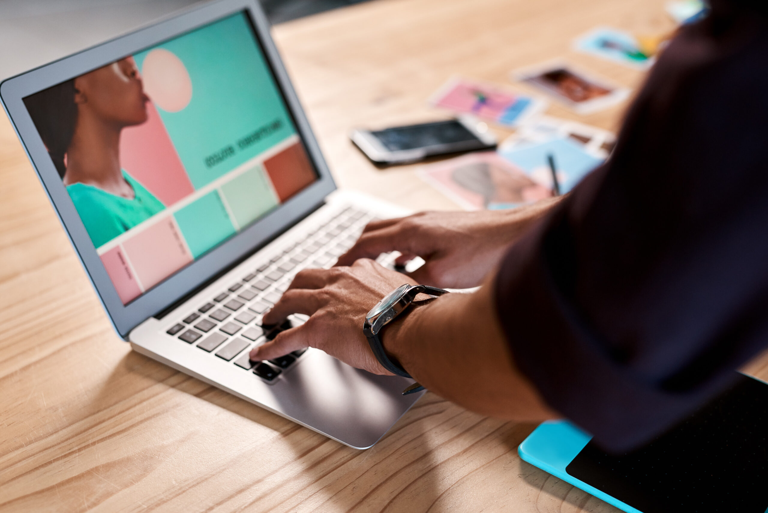 A professional editing brand visuals on a computer to boost brand visibility.